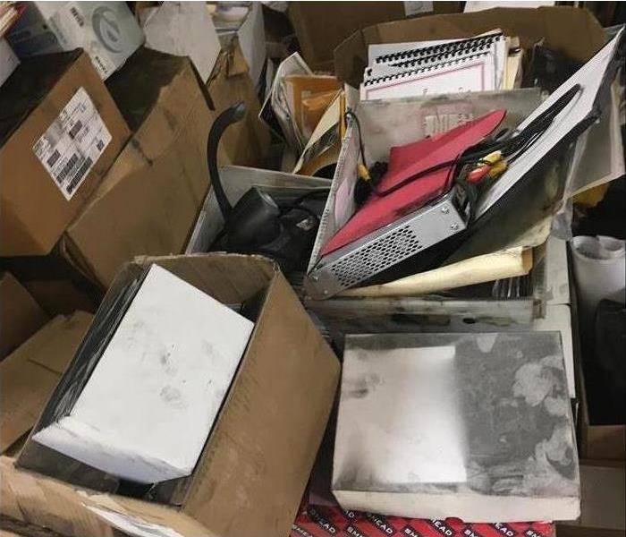 Documents in boxes with soot on them